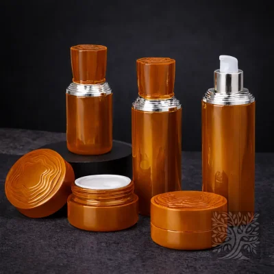 Warm amber skincare bottles and cosmetic jars in translucent finish, arranged with open jar on dark stone setting.