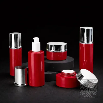 Bold red bottles and cosmetic jars with silver caps, presented on circular risers with lids placed beside containers.