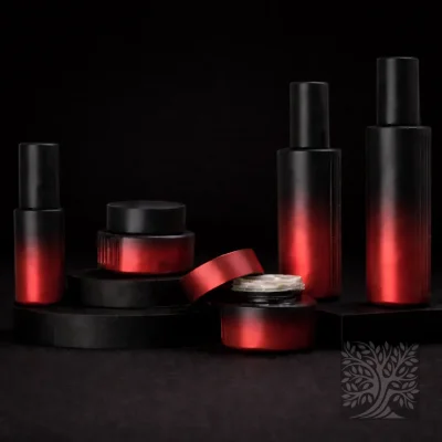 Black to red gradient serum bottles and cosmetic jars with matte finish, arranged in a Solace packaging display with an open jar.