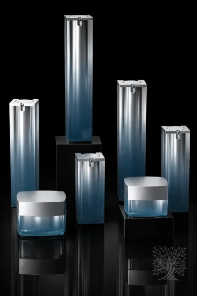 Frosted blue acrylic serum bottles and matching cosmetic jars with silver lids, styled in a modern display composition.