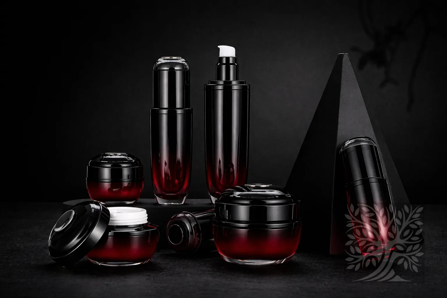 Dark red to black gradient acrylic skincare bottles and cosmetic jars with black caps, arranged on black stands in a bold presentation.