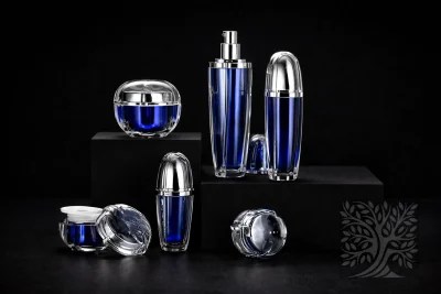 Deep blue acrylic skincare bottles and jars with chrome caps, displayed on dark platforms with layered arrangement.